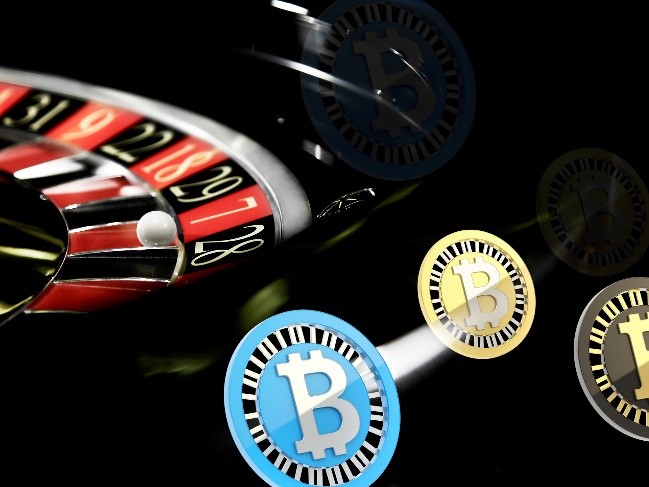 A roulette wheel with bitcoin chips